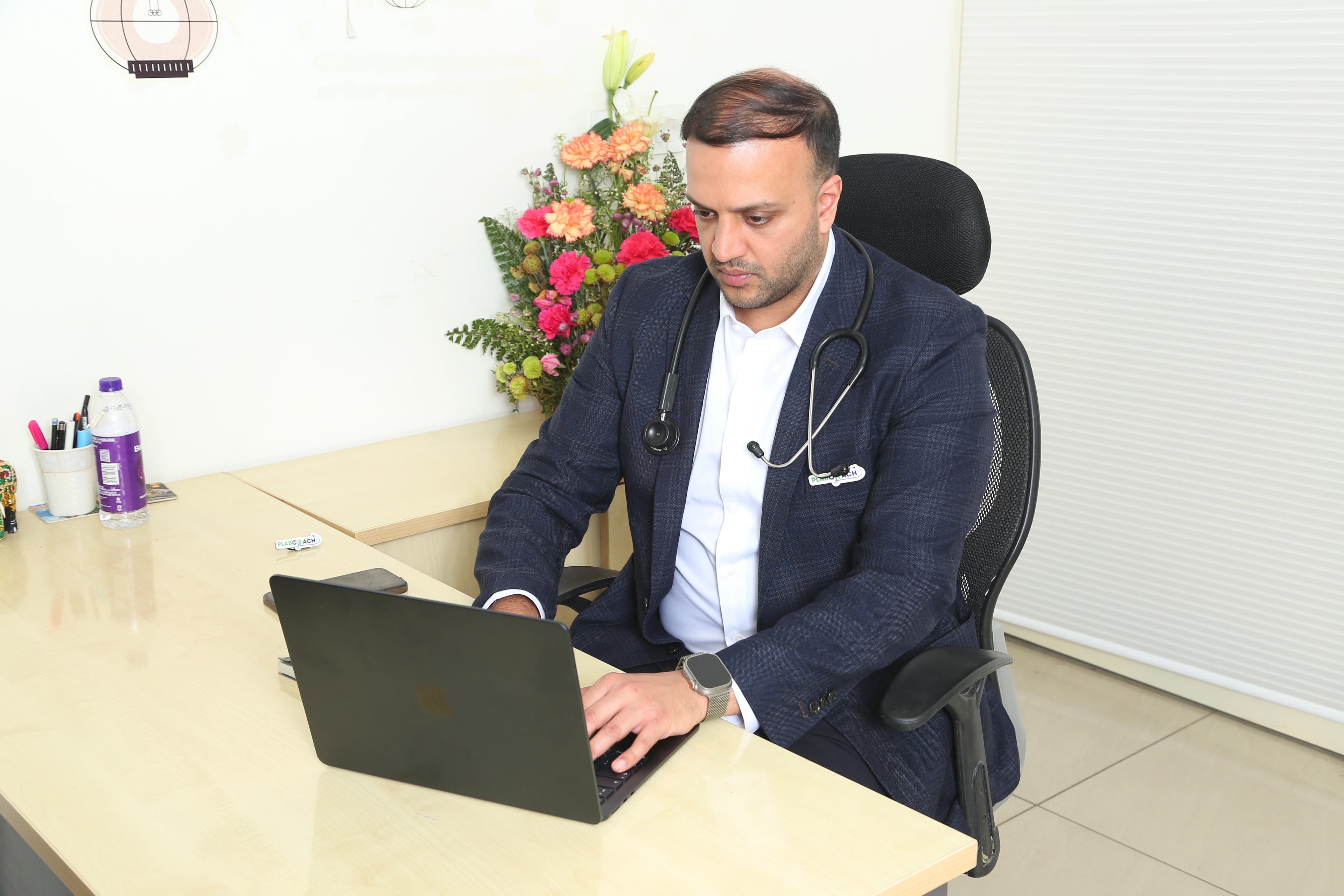 Doctor studying on a laptop